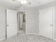 Bedroom featuring neutral walls, carpet floors, three doors, and a ceiling fan at 827 N Tacoma Ave, Indianapolis, IN 46201