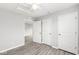 Bedroom with neutral walls, wood-look floors, three doors, and natural light at 827 N Tacoma Ave, Indianapolis, IN 46201