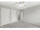Bedroom featuring neutral walls, carpet floors, three doors, and a ceiling fan at 827 N Tacoma Ave, Indianapolis, IN 46201