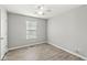 Bedroom with neutral walls, wood-look floors, a ceiling fan, and a window at 827 N Tacoma Ave, Indianapolis, IN 46201