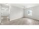 Bright bedroom with new flooring, featuring a ceiling fan and a window that brings in natural light at 827 N Tacoma Ave, Indianapolis, IN 46201