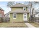 Charming home exterior with green siding, a white door, and a well-maintained yard at 827 N Tacoma Ave, Indianapolis, IN 46201