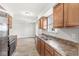 Open concept kitchen offering wood cabinets, updated stainless steel appliances, and view of the living area at 827 N Tacoma Ave, Indianapolis, IN 46201