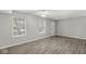 Living area featuring new flooring, large windows offering plenty of natural light, and modern ceiling fan at 827 N Tacoma Ave, Indianapolis, IN 46201