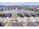 Aerial view of a residential area featuring well-maintained homes surrounding a scenic pond at 8861 Linton Ln, Brownsburg, IN 46112