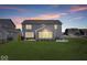 Spacious backyard featuring well-maintained lawn, a patio with outdoor seating, and a beautiful neighborhood view at 8861 Linton Ln, Brownsburg, IN 46112
