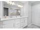 Bathroom with double sink vanity, ample lighting, and walk-in shower at 8861 Linton Ln, Brownsburg, IN 46112