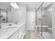 Bathroom featuring double vanity, walk-in shower with bench, and modern fixtures at 8861 Linton Ln, Brownsburg, IN 46112