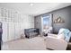 Cozy Bedroom with modern wallpaper, a gray crib, and a comfortable armchair at 8861 Linton Ln, Brownsburg, IN 46112