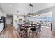 Open concept dining area with modern light fixtures and a seamless flow into the kitchen and living spaces at 8861 Linton Ln, Brownsburg, IN 46112