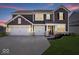 Beautiful two-story home featuring a three-car garage, landscaped yard, and welcoming front porch at 8861 Linton Ln, Brownsburg, IN 46112