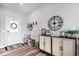 Inviting foyer with stylish decor, including a decorative wreath, wooden accents, and a large wall clock at 8861 Linton Ln, Brownsburg, IN 46112