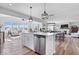 Open-concept kitchen with modern island, stainless steel appliances, and seamless integration with living spaces at 8861 Linton Ln, Brownsburg, IN 46112