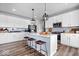 Bright kitchen featuring a central island with barstools, white cabinetry, and open view to the living space at 8861 Linton Ln, Brownsburg, IN 46112