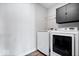 Functional laundry room with modern washer and dryer, plus cabinet storage at 8861 Linton Ln, Brownsburg, IN 46112