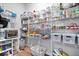 Well-organized pantry with white wire shelving, clear containers, and a variety of food items at 8861 Linton Ln, Brownsburg, IN 46112