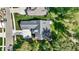 A top-down aerial view of a home's roof, driveway, and surrounding greenery, showcasing its architectural layout at 907 Oak Terrace Rd, Westfield, IN 46074