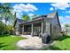 Gorgeous backyard with covered patio, stone accents, outdoor furniture, and lush landscaping for serene relaxation at 907 Oak Terrace Rd, Westfield, IN 46074