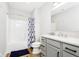 Bright bathroom featuring a shower and tub combination and modern gray vanity with white marble top at 907 Oak Terrace Rd, Westfield, IN 46074