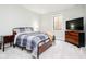 Bedroom featuring carpeted floors, a queen bed with a blue plaid comforter, and a window with natural light at 907 Oak Terrace Rd, Westfield, IN 46074