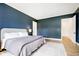 Modern primary bedroom with blue accent wall, floor-to-ceiling windows, and stylish, neutral-toned decor at 907 Oak Terrace Rd, Westfield, IN 46074