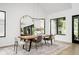 Bright dining room features a stylish light fixture and a large mirror to enhance the space at 907 Oak Terrace Rd, Westfield, IN 46074