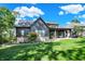 Beautiful exterior of home showcasing the backyard, a covered patio with fireplace, and lush lawn at 907 Oak Terrace Rd, Westfield, IN 46074