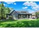 Beautiful exterior of home showcasing the backyard, a covered patio with fireplace, and lush lawn at 907 Oak Terrace Rd, Westfield, IN 46074