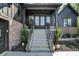 The front entrance boasts a stairway with black metal railings and a well-manicured landscape at 907 Oak Terrace Rd, Westfield, IN 46074