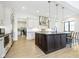 Contemporary kitchen with large island, stainless steel appliances, and bright, airy design with hardwood floors at 907 Oak Terrace Rd, Westfield, IN 46074