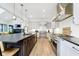 Open kitchen features an island, stainless steel appliances, light hardwood floors and sleek, modern cabinetry at 907 Oak Terrace Rd, Westfield, IN 46074