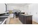 Laundry room with dark counters, island, and stainless steel appliances, plus sink and ample storage at 907 Oak Terrace Rd, Westfield, IN 46074