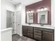 Bathroom featuring a double vanity with granite countertop and large mirrors at 9442 Orchard Cove Dr, Indianapolis, IN 46239