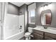 Bathroom featuring a shower-tub combo, gray walls, and a modern vanity with mirror at 9442 Orchard Cove Dr, Indianapolis, IN 46239