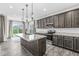 Modern kitchen featuring stainless steel appliances, island, and gray cabinets at 9442 Orchard Cove Dr, Indianapolis, IN 46239