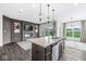 Modern kitchen overlooking the living area and features an island with a sink at 9442 Orchard Cove Dr, Indianapolis, IN 46239