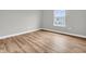 Bedroom featuring wood floors, neutral paint, white trim, and a window at 9657 Rialto Trl, Carmel, IN 46280