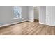 Bedroom showcasing wood floors, a window with a view of the neighborhood, and white trim at 9657 Rialto Trl, Carmel, IN 46280