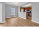 Bright dining area showcasing beautiful flooring and a view into the kitchen with stainless steel appliances at 9657 Rialto Trl, Carmel, IN 46280