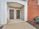 Inviting entryway featuring two doors, classic lighting and traditional hardware and brick facade at 9657 Rialto Trl, Carmel, IN 46280