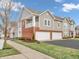 Charming townhome features a two-car garage, brick accents, and a covered porch at 9657 Rialto Trl, Carmel, IN 46280