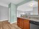 Kitchen with granite countertops, stainless steel sink and dishwasher, open to the living space at 9657 Rialto Trl, Carmel, IN 46280