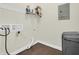 Laundry room featuring wood floors, a washing machine, and wire shelving at 9657 Rialto Trl, Carmel, IN 46280