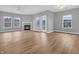 Bright living room with laminate floors, fireplace, large windows, and modern lighting at 9657 Rialto Trl, Carmel, IN 46280