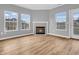 Inviting living room area with a cozy fireplace, neutral paint, and plenty of natural light at 9657 Rialto Trl, Carmel, IN 46280