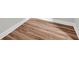 Close-up of a wood floor with white trim and a corner at 9657 Rialto Trl, Carmel, IN 46280