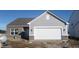 Charming single-story home features a two-car garage, brick accents, and horizontal siding under a blue sky at 10126 Camp Creek Way, Indianapolis, IN 46229