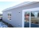 Exterior view of gray vinyl siding, large window, and sliding glass door to back yard at 10126 Camp Creek Way, Indianapolis, IN 46229