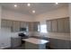 Modern kitchen with gray cabinetry, stainless steel appliances, quartz countertops, and a center island at 10126 Camp Creek Way, Indianapolis, IN 46229
