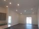 Bright and airy living room boasts recessed lighting, a sliding glass door, and modern, neutral finishes at 10126 Camp Creek Way, Indianapolis, IN 46229